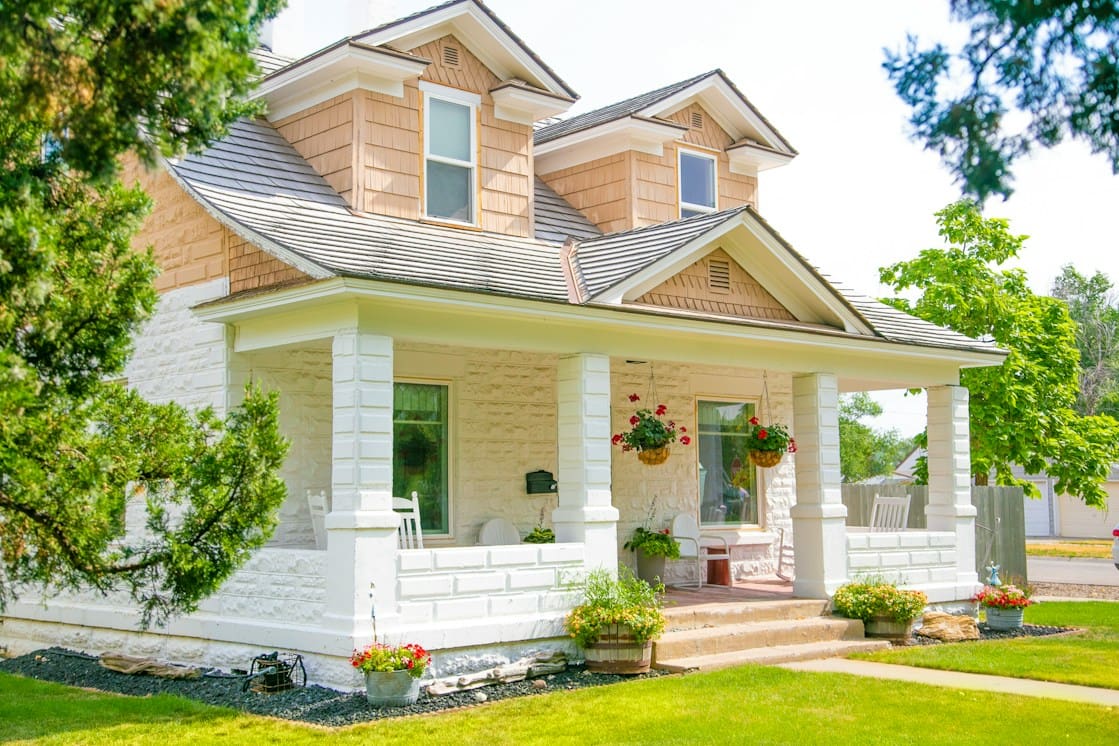 House with a covered front porch and flower beds